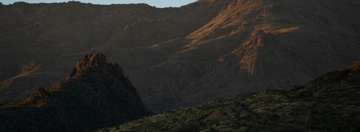 Rugged Arizona desert mountains catching the last light of sunset